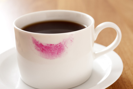 Cup of coffee with feminine lipstick marks