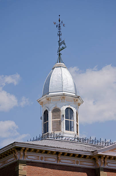 Old Courthouse Cupola and Weathervane The courthouse in downtown Buena Vista, Colorado reflects the history of the time in which it was built.  The late 1800's in Colorado was a rowdy time of growth, yet the Victorian architecture was stately and elegant.  Here the cupola is decorated with arched windows, shutters and a deer weathervane. wrought iron colorado courthouse victorian style stock pictures, royalty-free photos & images