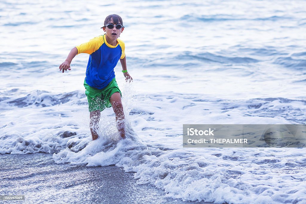 kid splashing water in the beach  10-11 Years Stock Photo