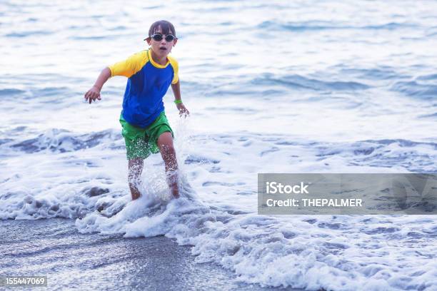 Kid Splashing Water In The Beach Stock Photo - Download Image Now - 10-11 Years, Beach, Beach Holiday