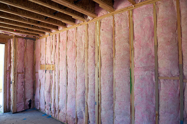Wall of pink insulation in house stock photo
