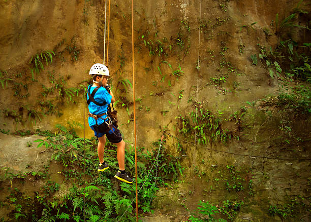 A young woman is belat=ying from the crag on a beautiful day