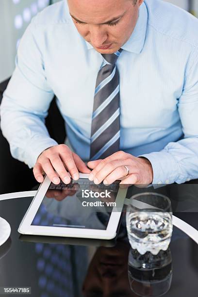 Businessman Typing On Digital Tablet Stock Photo - Download Image Now - 30-34 Years, Adult, Adults Only