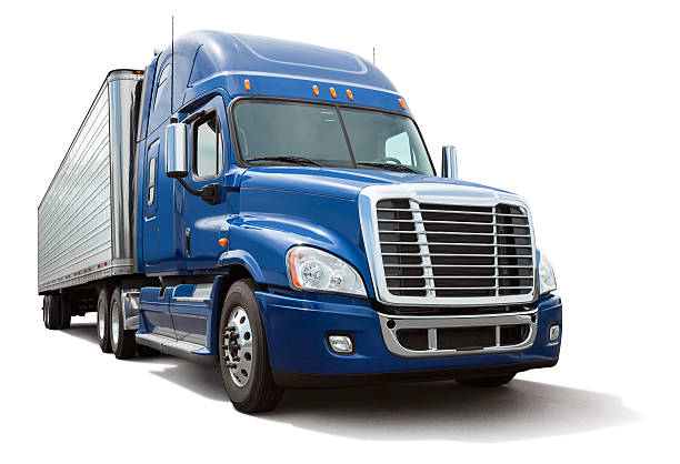 Isolated Eighteen Wheel Semi Truck with Blue Cab on White Blue semi truck or 18 wheeler hauling a metal cargo bay isolated on white. Clipping path provided for truck. Canon 5DMarkII. File meticulously cleaned up in Photoshop. articulated lorry stock pictures, royalty-free photos & images