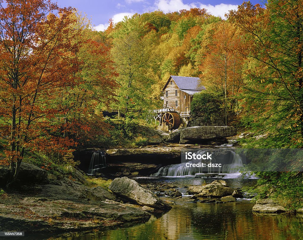 Glade Creek Grist Mill nostalgia blazing autumn colors West Virginia Picturesqe old Glade Creek Grist Mill with waterwheel and stream, in a blazing autumn colors setting.  Babcock State Park. Autumn Stock Photo