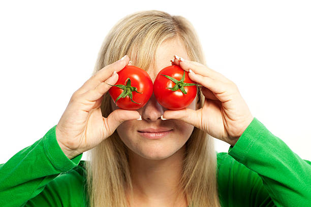 istock Blonde woman with tomatos on eyes 155447387