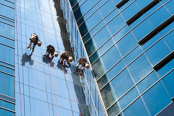 Photo of Window washer team cleaning high rise exterior