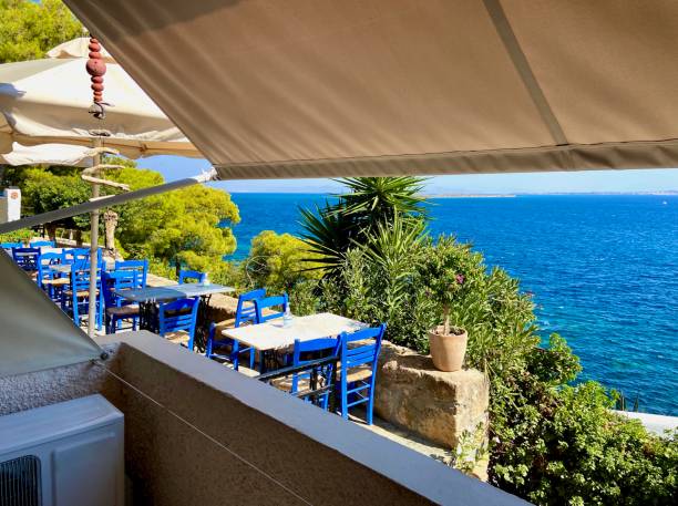 istock Shady hotel balcony with awning and air conditioning overlooking a restaurant facing the Aegean Sea on a hot summer day on the island of Agistri, Greece 1554495765