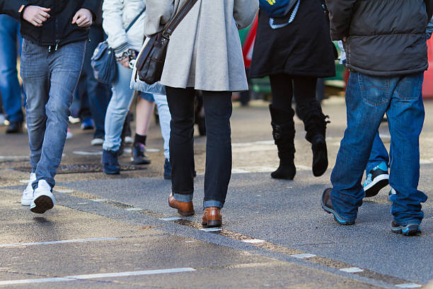 istock unrecognizable people crossing the street 155450187