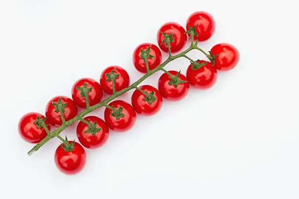truss of cherry tomatoes isolated on white