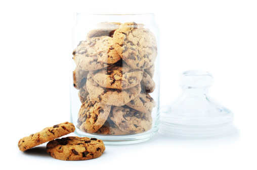 Open glass jar with chocolate chip cookie