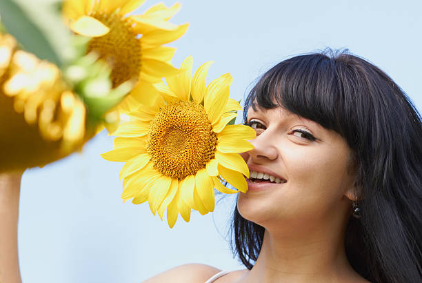 istock Young girl playing with sunflower 155451277