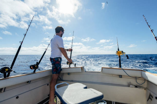 istock Man sitting on a boat and fishing for tuna fish. 1554518239