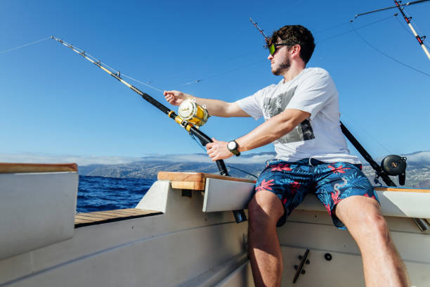 istock Man sitting on a boat and fishing for tuna fish. 1554518672