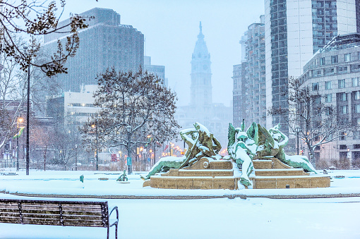 Center city Philadelphia in the snow. Ben Franklin parkway public park. Swann memorial fountain at Logan square park.