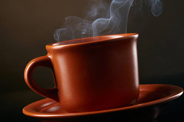 istock Cup of coffee with smoke over dark background 155453260
