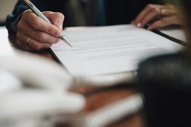 istock Low angle view of businesswoman proofreading a document 1554533995