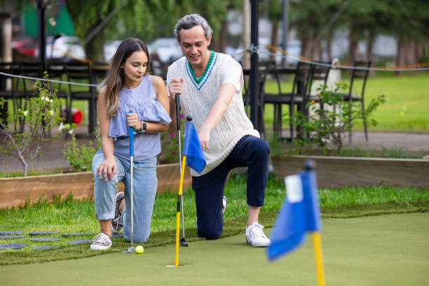 istock Couple calculating their shot in miniature golf 1554534727