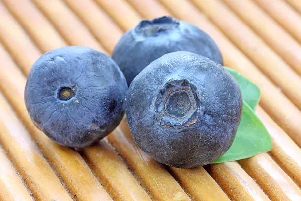 Photo of Bilberry. Blueberries a wooden pad.