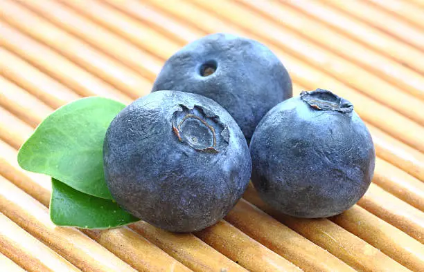 Photo of Bilberry. Blueberries a wooden pad.