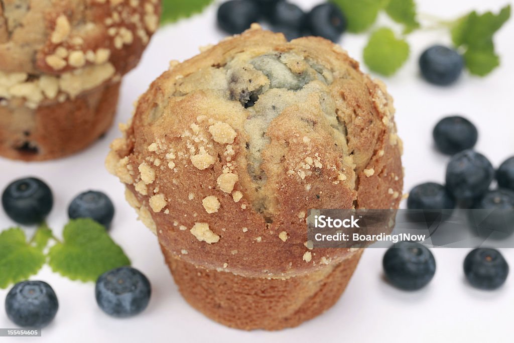 Fresh blueberry muffins Freshly baked blueberry muffins served with blueberries Baked Pastry Item Stock Photo