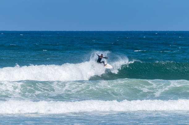 istock Surfer riding waves in Furadouro Beach 1554552170