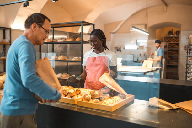 istock Black Female Offering Freshly Baked Bread At An Artisan Bakery 1554553753