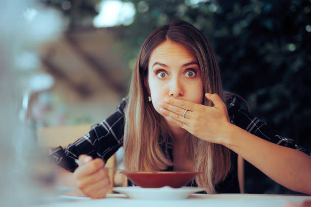 istock Woman Trying Food Feeling Sick Instantly from first Chewing 1554639861