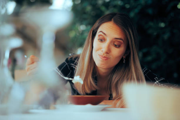 istock Unhappy Customer Trying and Disliking a Restaurant Dish 1554639863