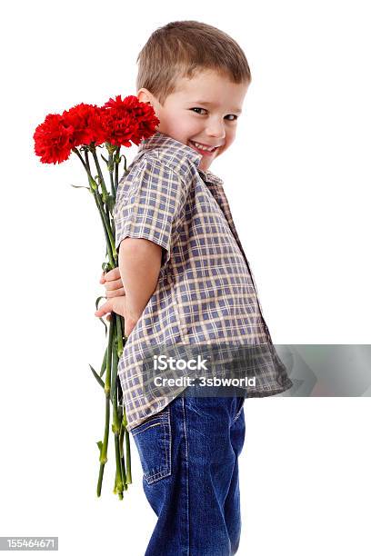 Niño Sonriente Esconde Un Ramo Foto de stock y más banco de imágenes de Niño - Niño, Flor, Niños