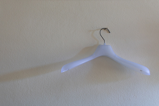 white plastic hangers on a white background