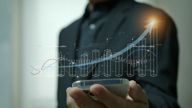 Businessman working with smartphone, showing chart and graph icons on virtual hologram digital screen interface. Big data analytics, BI business intelligence, investment and financial concept.