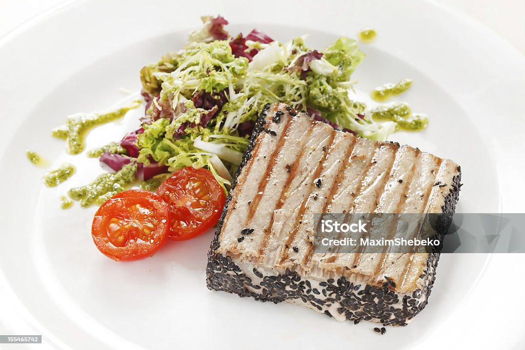 salmon steak with salad Arugula Stock Photo