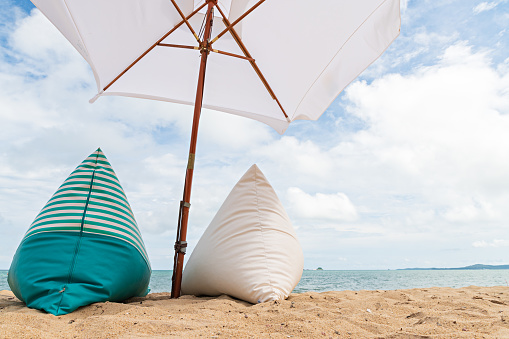 Beautiful sea beach with chairs and umbrellas. hot sun festival. Picnic equipment for beach trips.