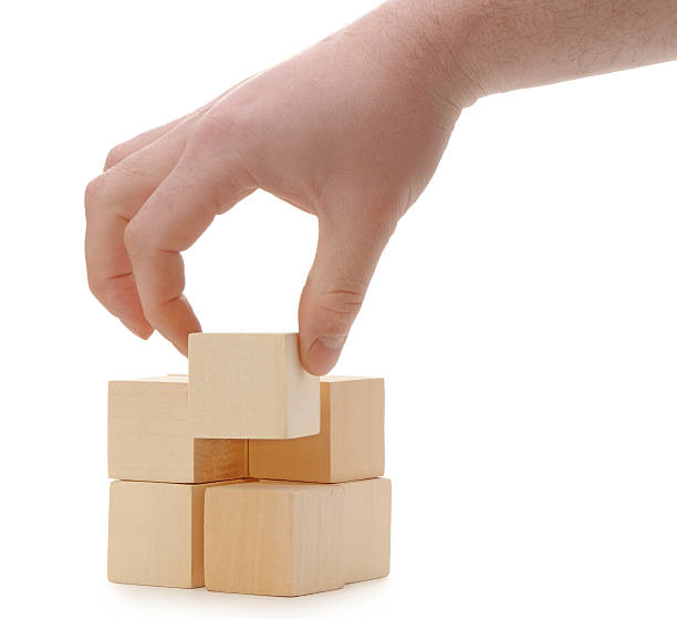 istock The hand establishes a wooden cube 155467627