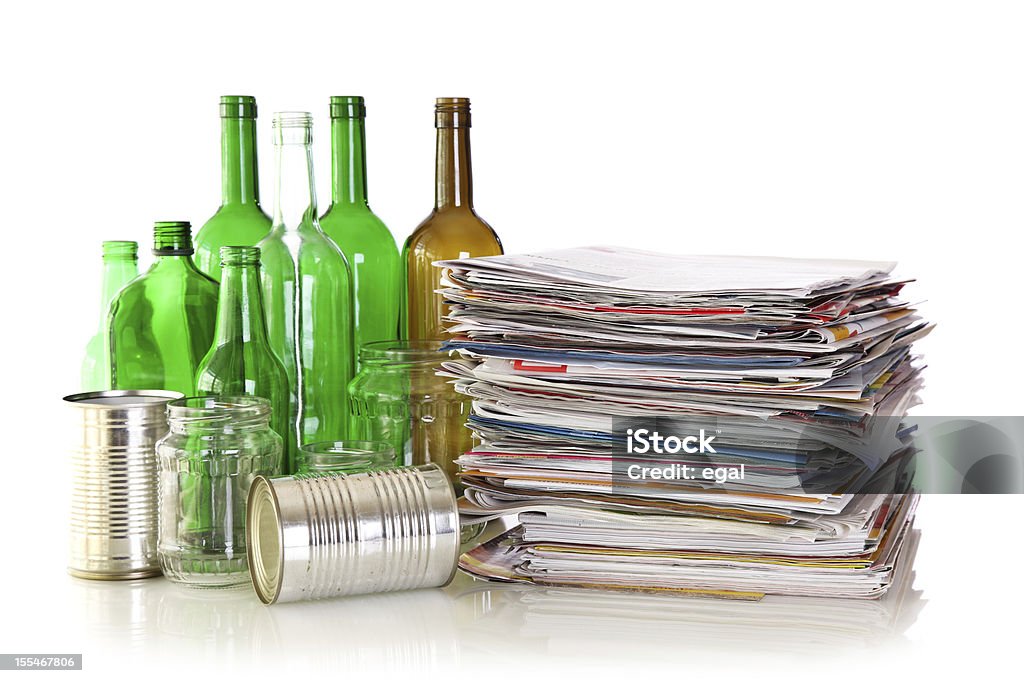 Glass bottles, metal cans and newspapers Glass bottles, metal cans and newspapers ready for recycling Recycling Stock Photo