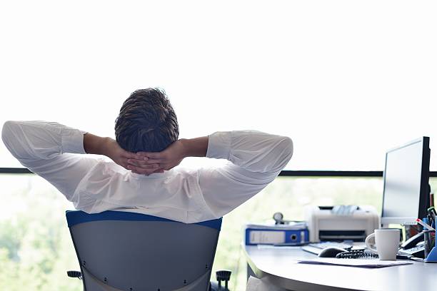 istock A happy young business man relaxing at his office 155467879