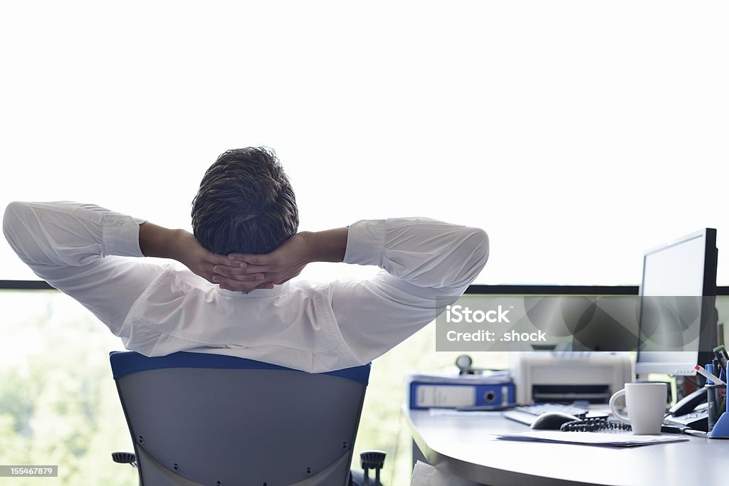 A happy young business man relaxing at his office happy young business  man work in modern office on computer Businessman Stock Photo