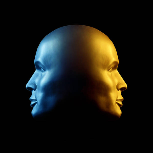 Two-faced head statue, blue and gold Two-faced head statue with one face gold, the other blue.. psyche photography stock pictures, royalty-free photos & images