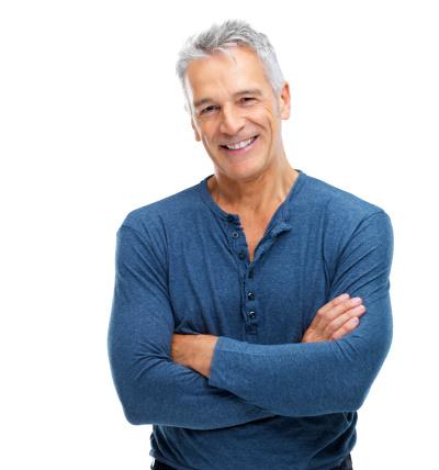 Portrait of a fit senior man smiling with arms crossed while isolated on white background