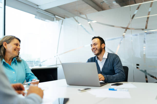 istock Office colleagues smiling at meeting 1554764720