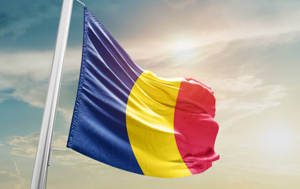 istock chad national flag waving in beautiful sky. 1554825112