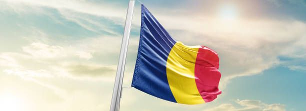 istock chad national flag waving in beautiful sky. 1554825541