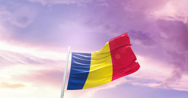 istock chad national flag waving in beautiful sky. 1554827679