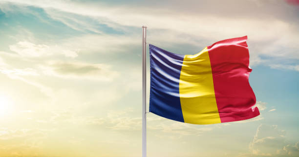 istock chad national flag waving in beautiful sky. 1554827717