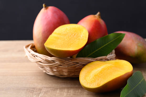 Mango fruit (Palmer mango) in basket on wooden background, Tropical fruit stock photo