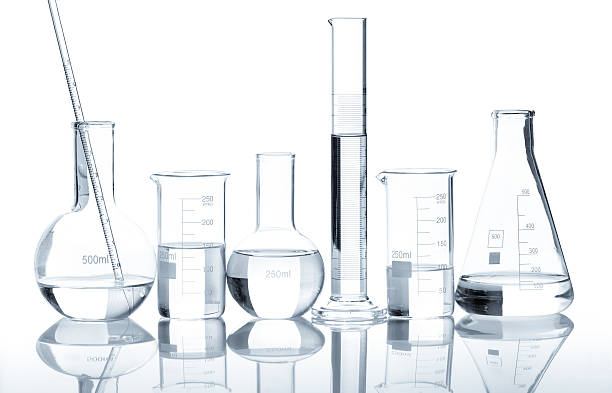Group of laboratory flasks with a clear liquid Group of laboratory flasks with a clear liquid, isolated beaker stock pictures, royalty-free photos & images