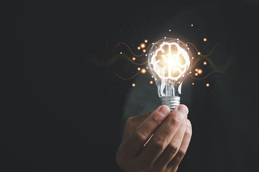 Hand holding light bulb, signifying the concept of innovative ideas and creative thinking. bright solutions and power of imaginative minds. moment of inspiration and success in business and technology