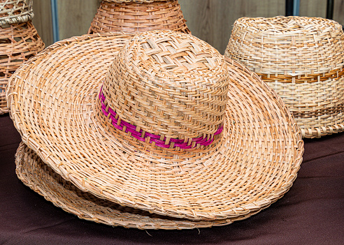 Handmade sombrero (Panama Hat) made from natural plant fiber at the traditional outdoor market in Cuenca, Ecuador.