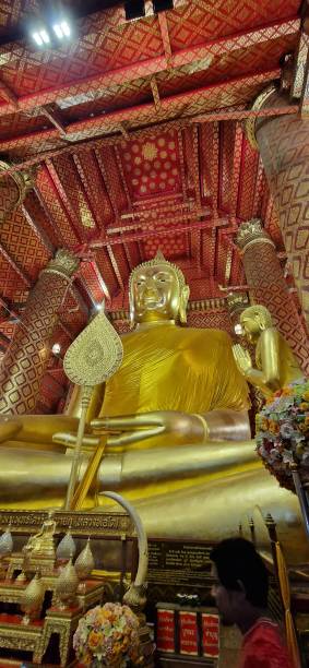 istock Golden Buddha Ayutthaya  close up with red decorative ceiling 1554908977